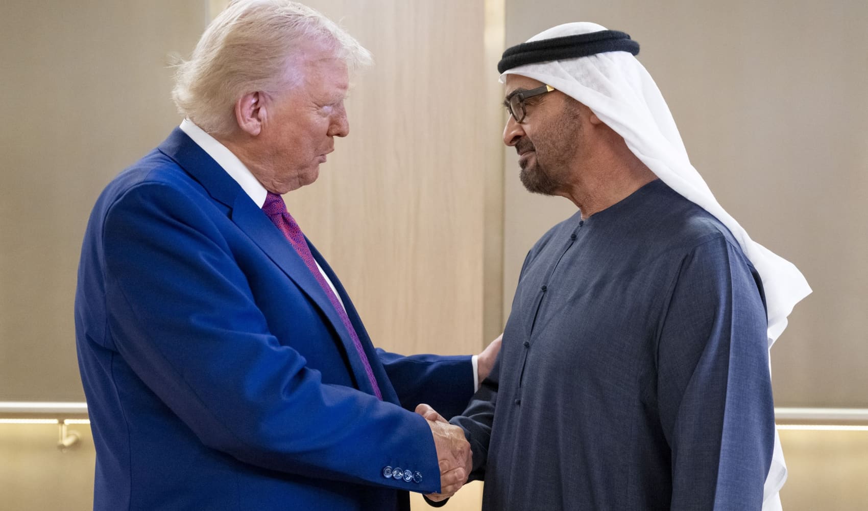 UAE President Sheikh Mohamed bin Zayed Al Nahyan (R) welcomes his US counterpart Donald Trump upon arrival at the presidential terminal in Abu Dhabi on May 15, 2025.