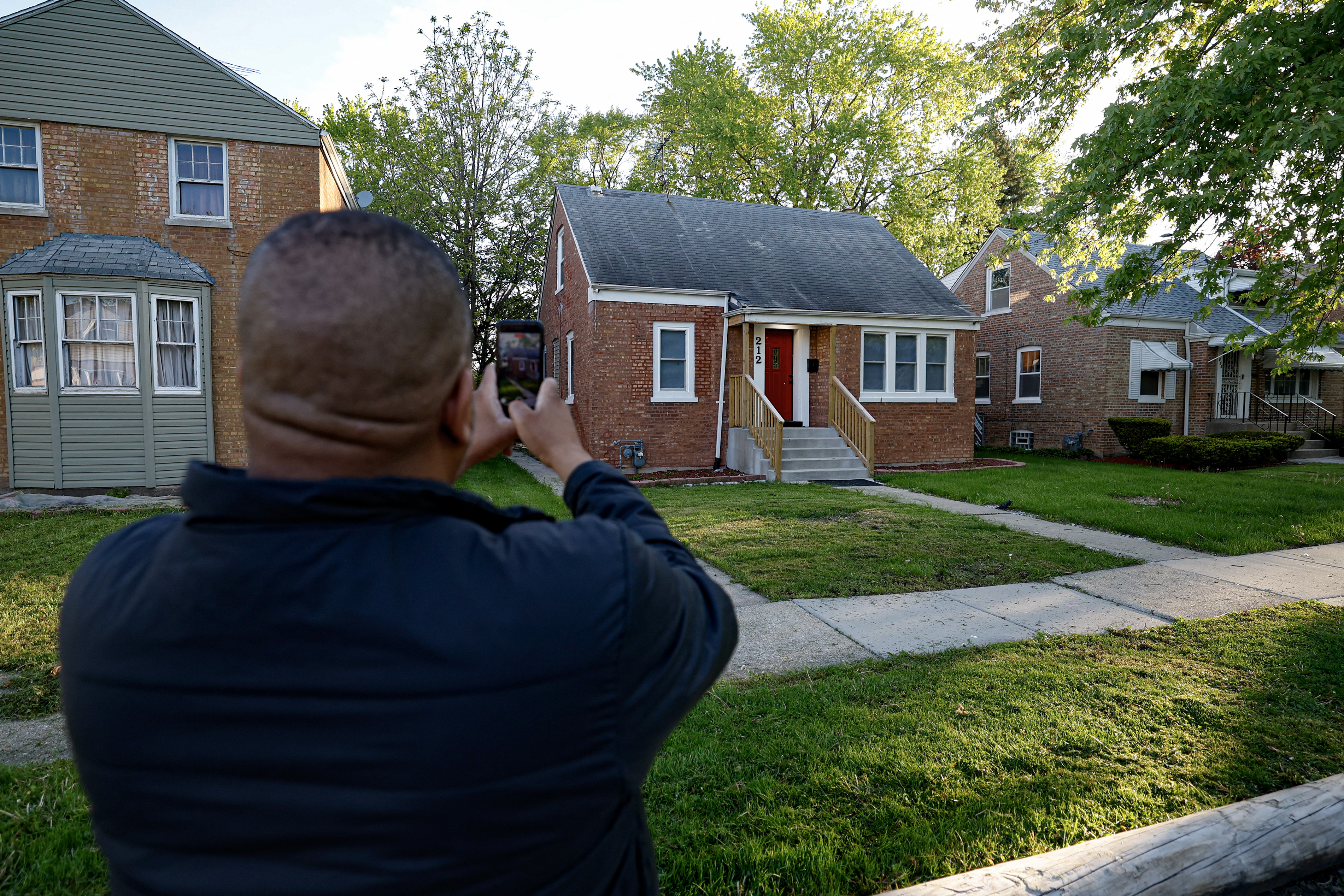 A person takes a picture of the childhood home of the new Pope Leo XIV in Dolton, Illinois, on May 9, 2025. Robert Francis Prevost became the first pope from the United States on May 8, 2025, picking the papal name Leo XIV after cardinals from around the world elected him leader of the world’s 1.4 billion Catholics. Tens of thousands of people packed in St Peter’s Square cheered as Prevost appeared on the balcony of St Peter’s Basilica, waving with both hands, smiling and bowing. (Photo by KAMIL KRZACZYNSKI / AFP) (Photo by KAMIL KRZACZYNSKI/AFP via Getty Images)